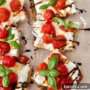 Caprese Bruschetta with balsamic glaze, a perfect blend of roasted tomatoes, pesto, and burrata.