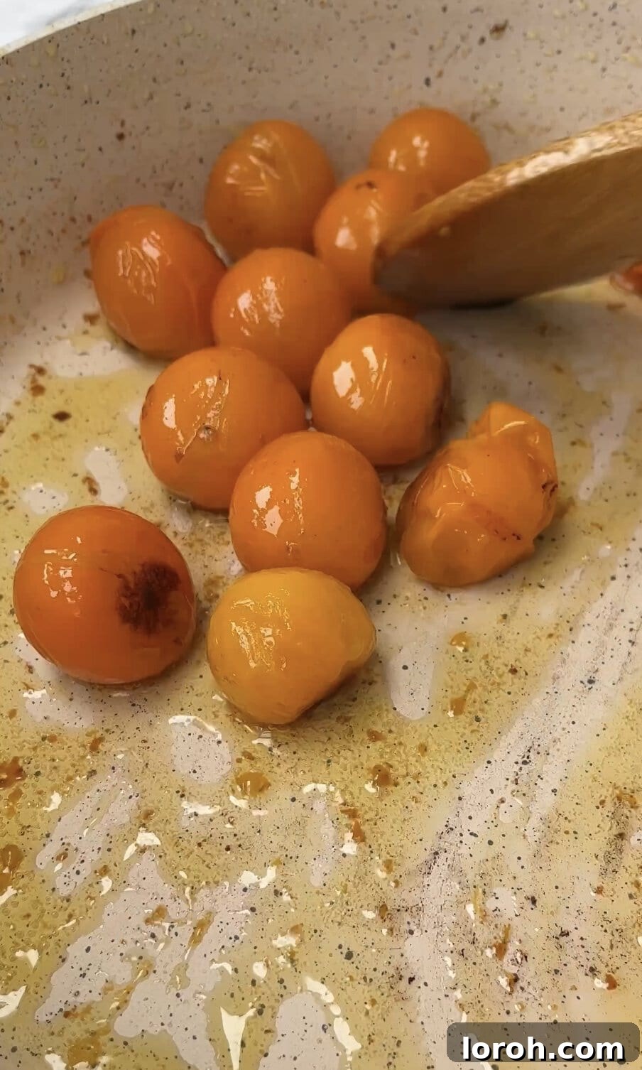 Blistering vibrant cherry tomatoes in a pan, a key step for flavorful risotto.