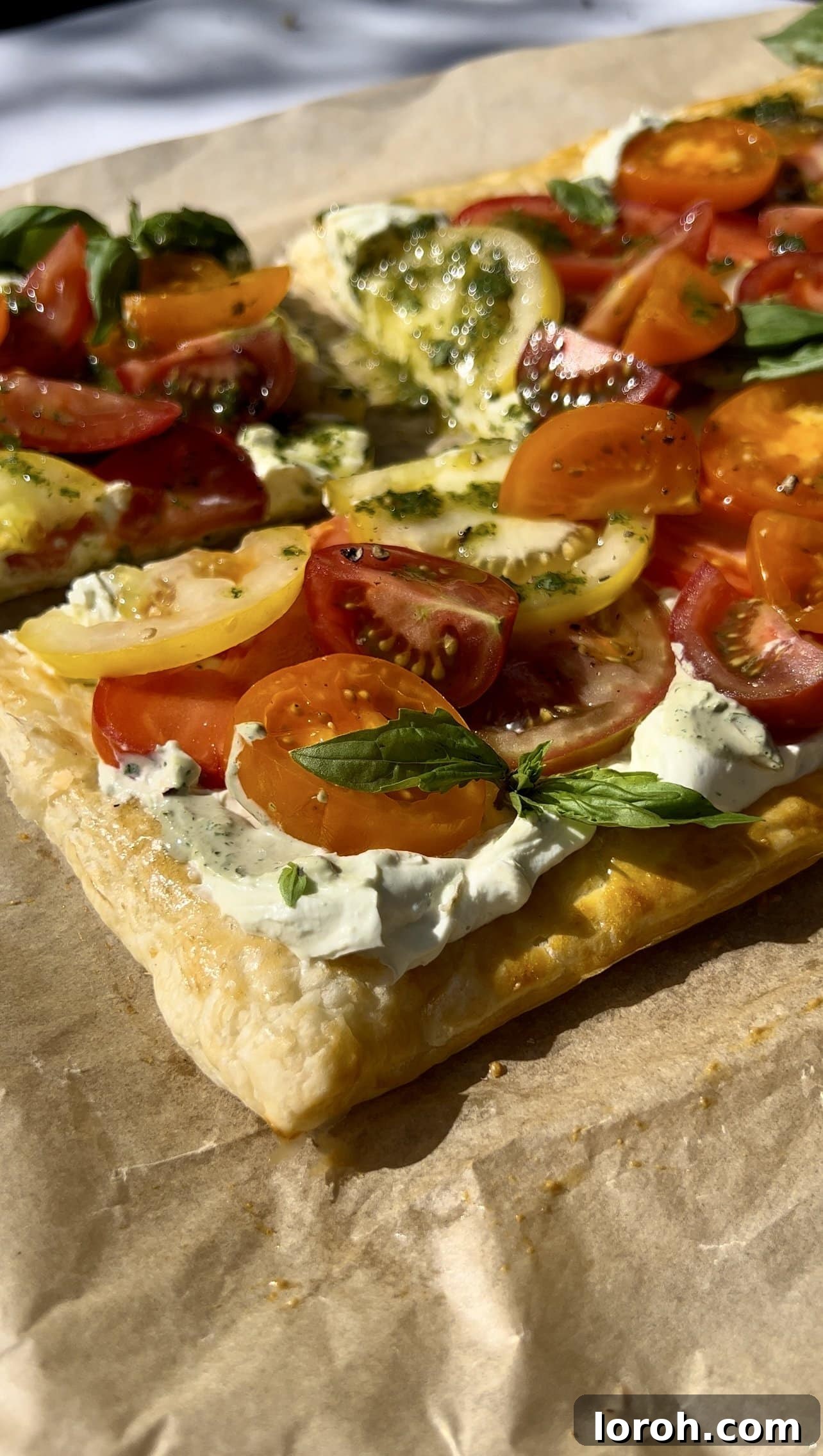 Vibrant puff pastry tomato tart with fresh basil and creamy ricotta