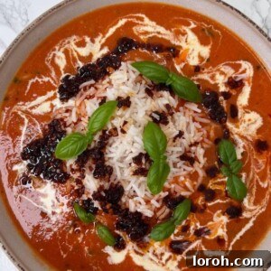 Roasted Fresh Tomato and Garlic Soup served over fluffy rice in a rustic bowl