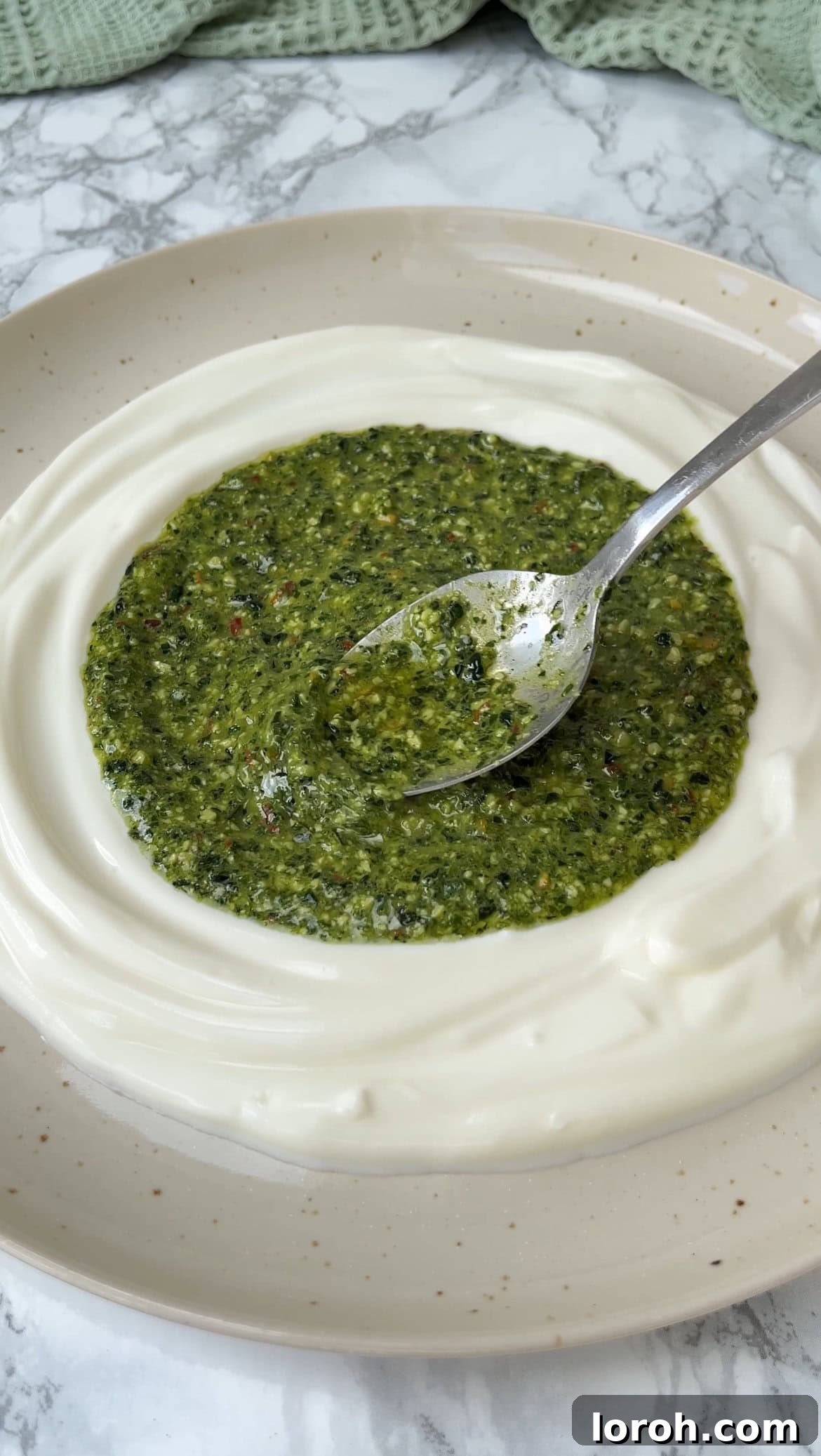 Rustic Herb Roasted Potatoes and Piquant Cavolo Nero Chimichurri 7 Spreading chimichurri over creamy yogurt on a plate