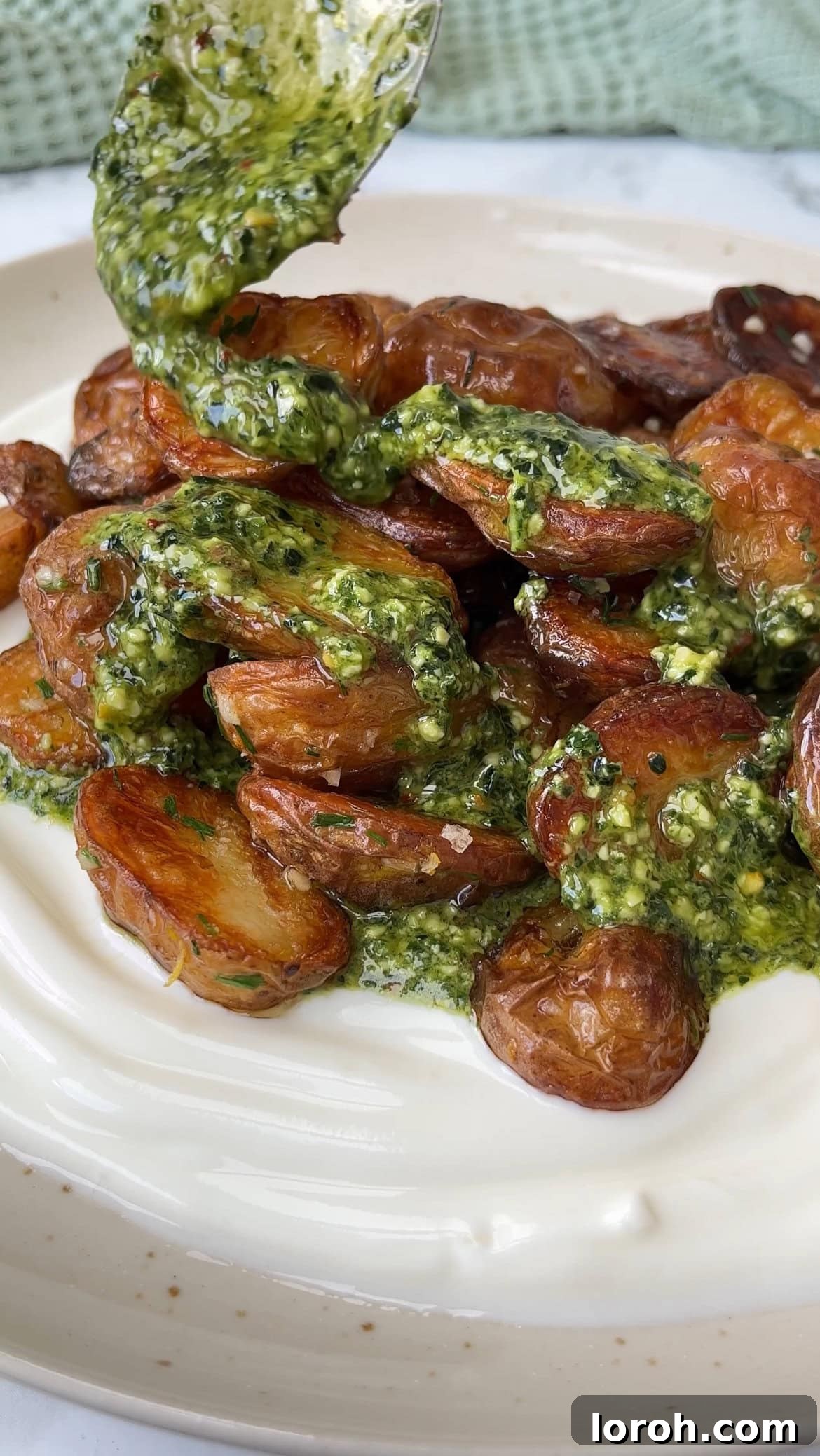 Rustic Herb Roasted Potatoes and Piquant Cavolo Nero Chimichurri 8 Final dish of herb roasted potatoes on yogurt with chimichurri and garnishes
