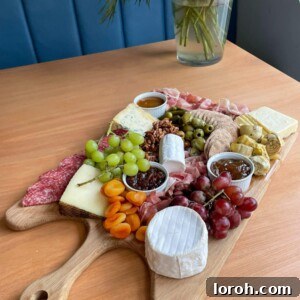 Beautifully arranged cheeseboard with a variety of cheeses, fruits, nuts, and crackers, perfect for entertaining