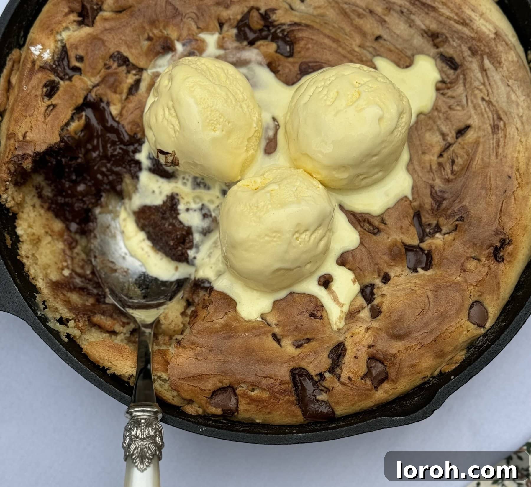 Effortless Condensed Milk Cookie Bars 3 Chocolate Chip Skillet Cookie slices with a scoop of vanilla ice cream.