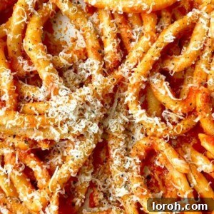 Exquisite tomato sauce tossed through pasta, illustrating the simplicity and allure of Marcella Hazan's famous 4-ingredient recipe