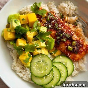 teriyaki salmon bowl with mango avocado salsa and rice.