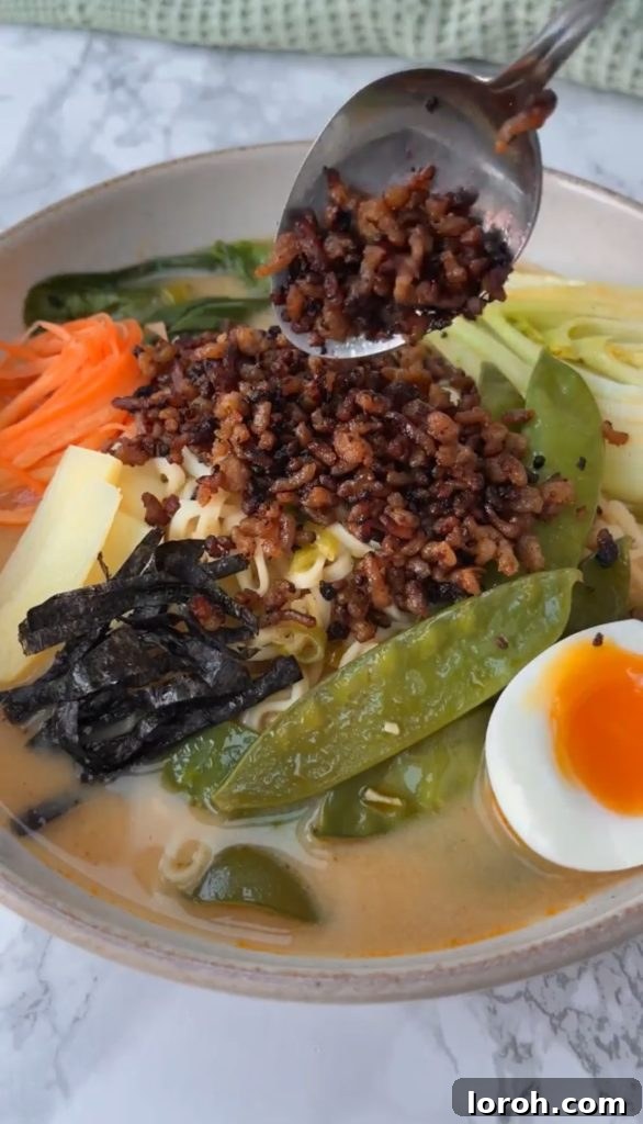 Adding crispy pork to the easy pork ramen