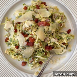 Beautifully plated shaved Brussels sprouts salad, dressed with creamy Caesar dressing