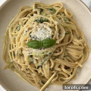 Lemon Courgette Pasta in a beige bowl with a fork in the pasta