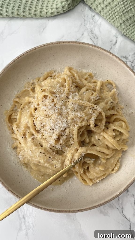Golden Onion Brown Butter Pasta 2 A bowl of Brown Butter Pasta with Caramelized Onions, garnished with fresh herbs and a fork in the pasta.