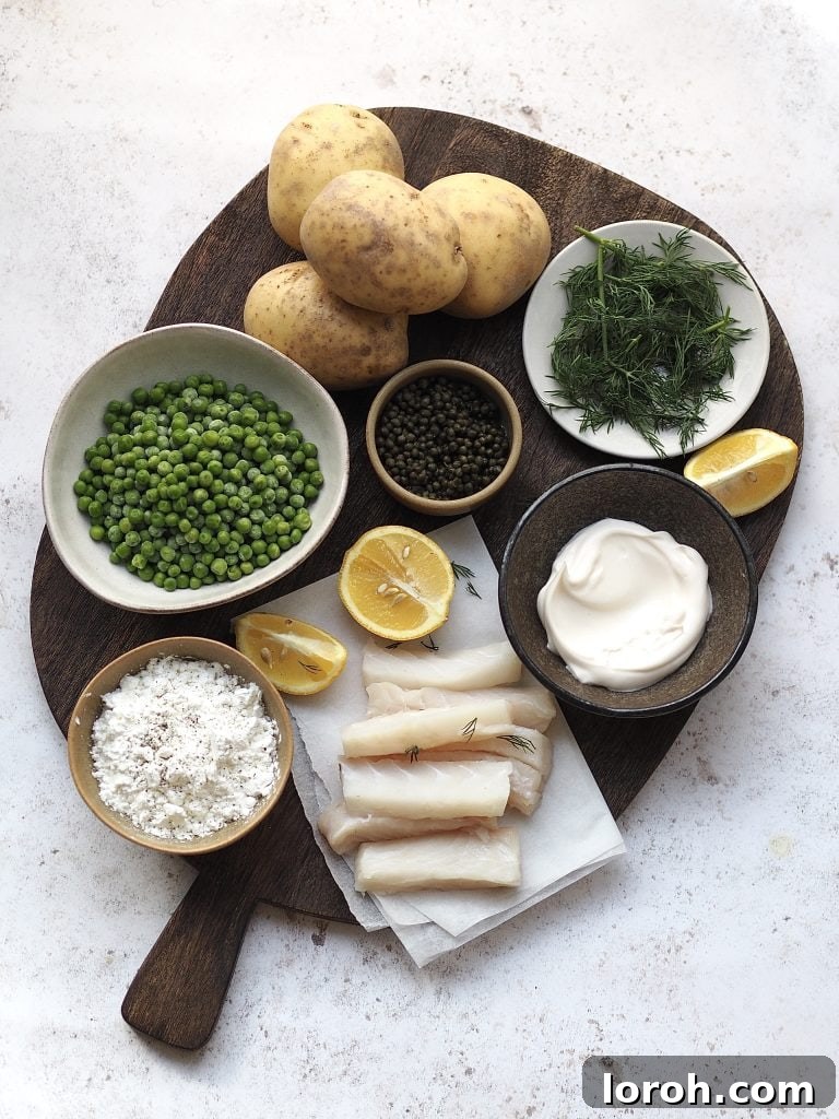 Golden Crispy Cod with Tartar Zing 4 Wooden board with all the ingredients to make fish goujons with smashed minty peas, potato wedges and tartare sauce.