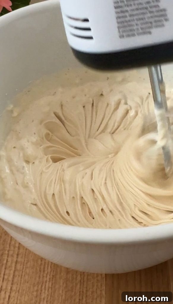 Five Ingredient No Bake Biscoff Cheesecake 6 A close-up shot of the Biscoff cheesecake mixture being whisked to the perfect thick consistency, ready for assembly.