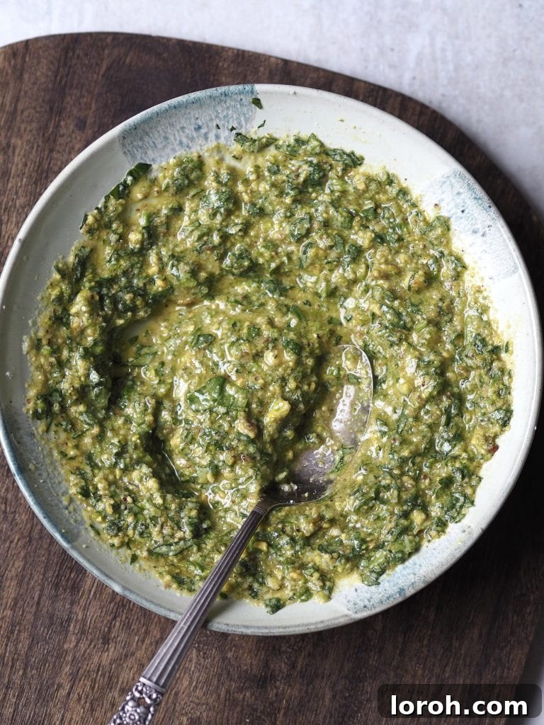 Crispy Chicken with Mediterranean White Bean Salad 8 Close up of a grey bowl of homemade basil pesto.