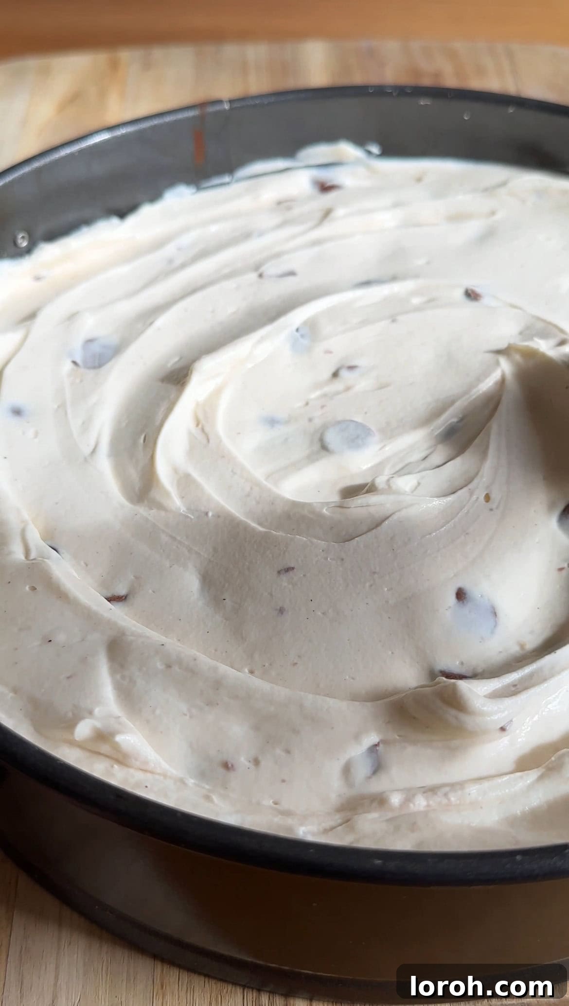 The Mini Egg cheesecake filling smoothly spread over the biscuit base, creating an even top layer before chilling, ready for the final set.