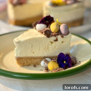 A vibrant slice of Mini Egg Cheesecake on a white plate, revealing a rich chocolate biscuit base, creamy filling with crushed mini eggs, and a light whipped cream topping, ready to be enjoyed.
