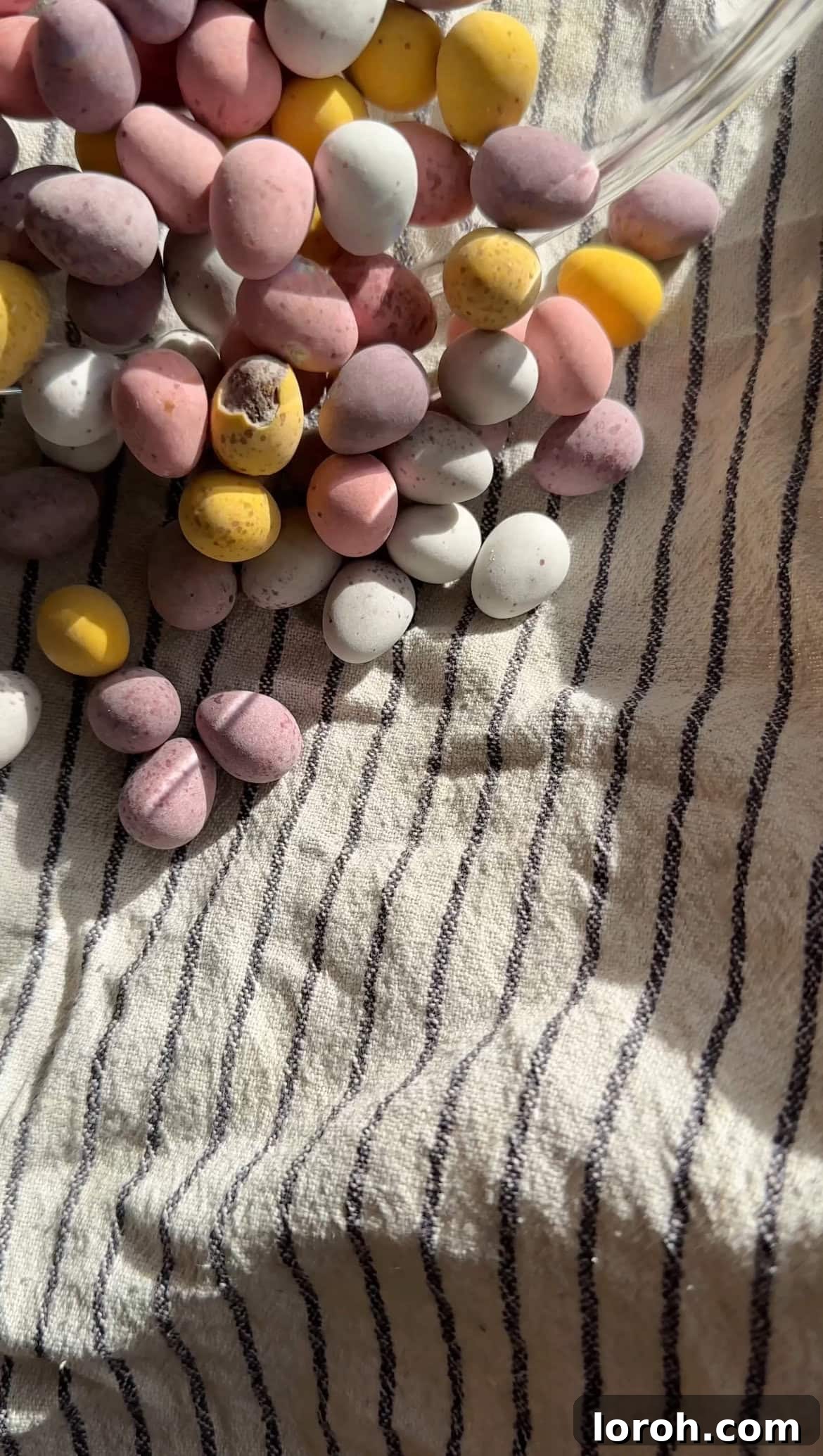 Mini Eggs covered in a tea towel, ready to be crushed for the cheesecake filling, ensuring a clean and contained process.