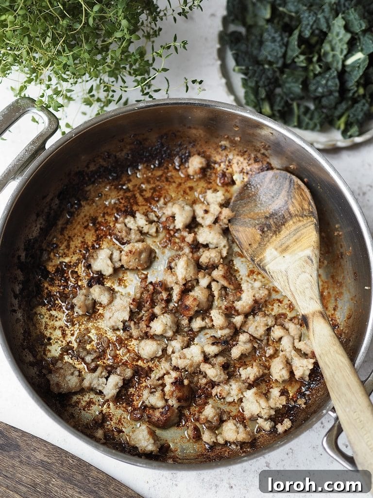 Chili-Fennel Sausage Rigatoni with Tuscan Kale 5 Sausage pieces being caramalised in a frying pan.