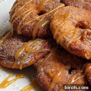 Appelflappen on a white plate with caramel sauce.