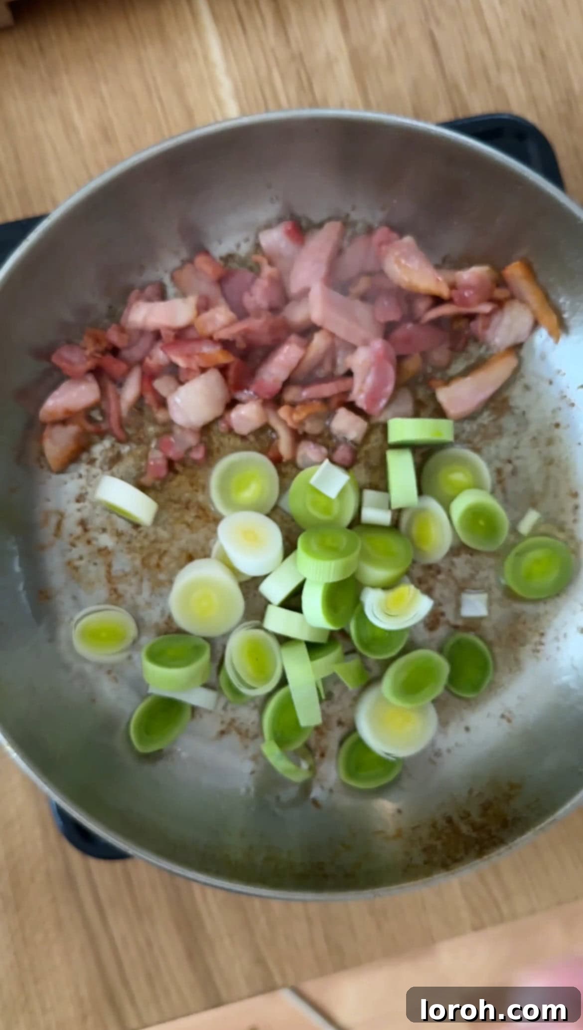 Leeks being sautéed in the same pan, absorbing the delicious rendered pancetta fat.