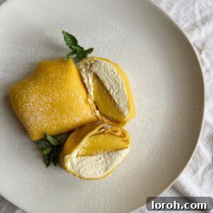 folded mango pancakes on a white plate, ready to serve