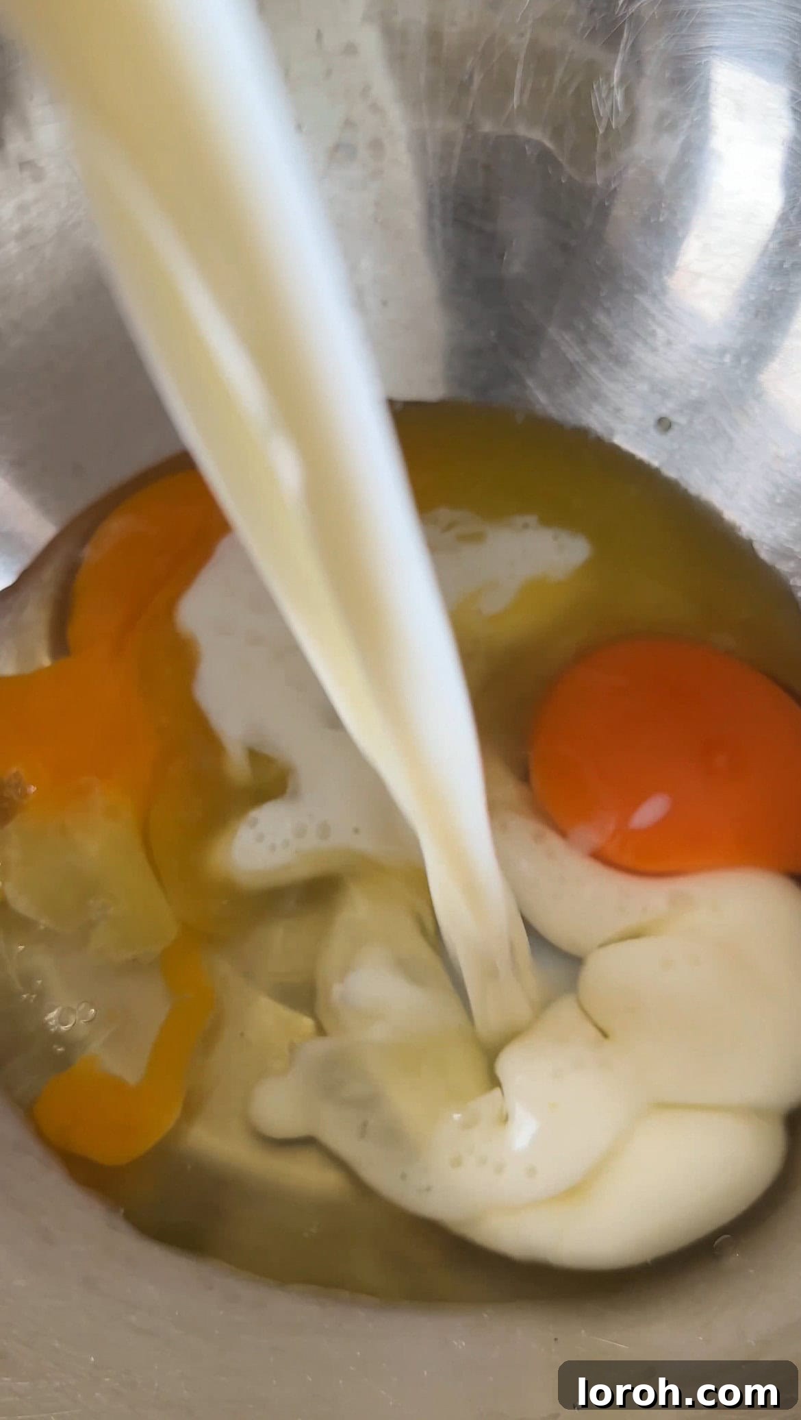 making batter for mango pancakes, showing wet ingredients being whisked