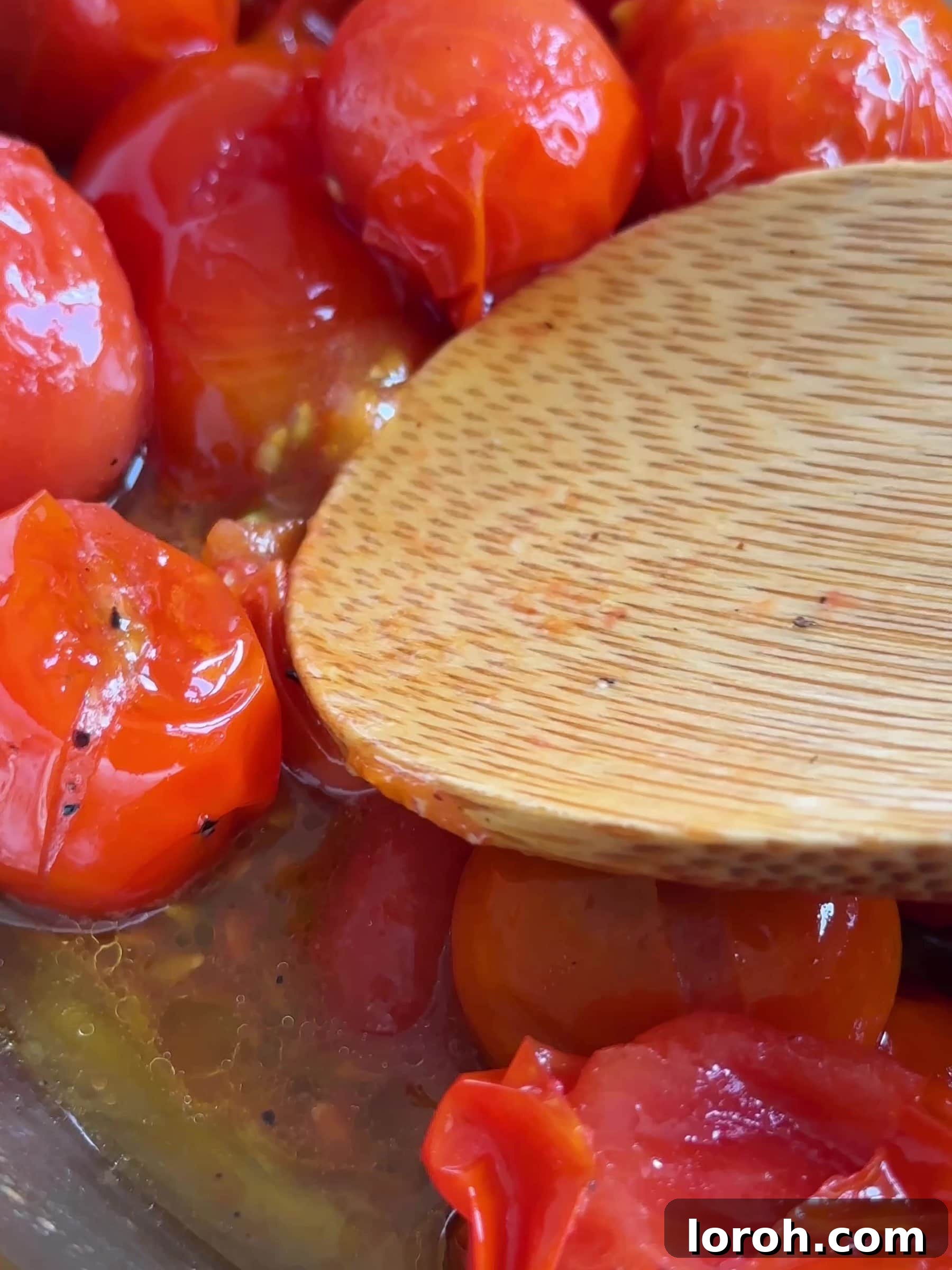Creamy Tuna Pasta with Sweet and Spicy Tomatoes 6 Cherry tomatoes softening and bursting in a frying pan.