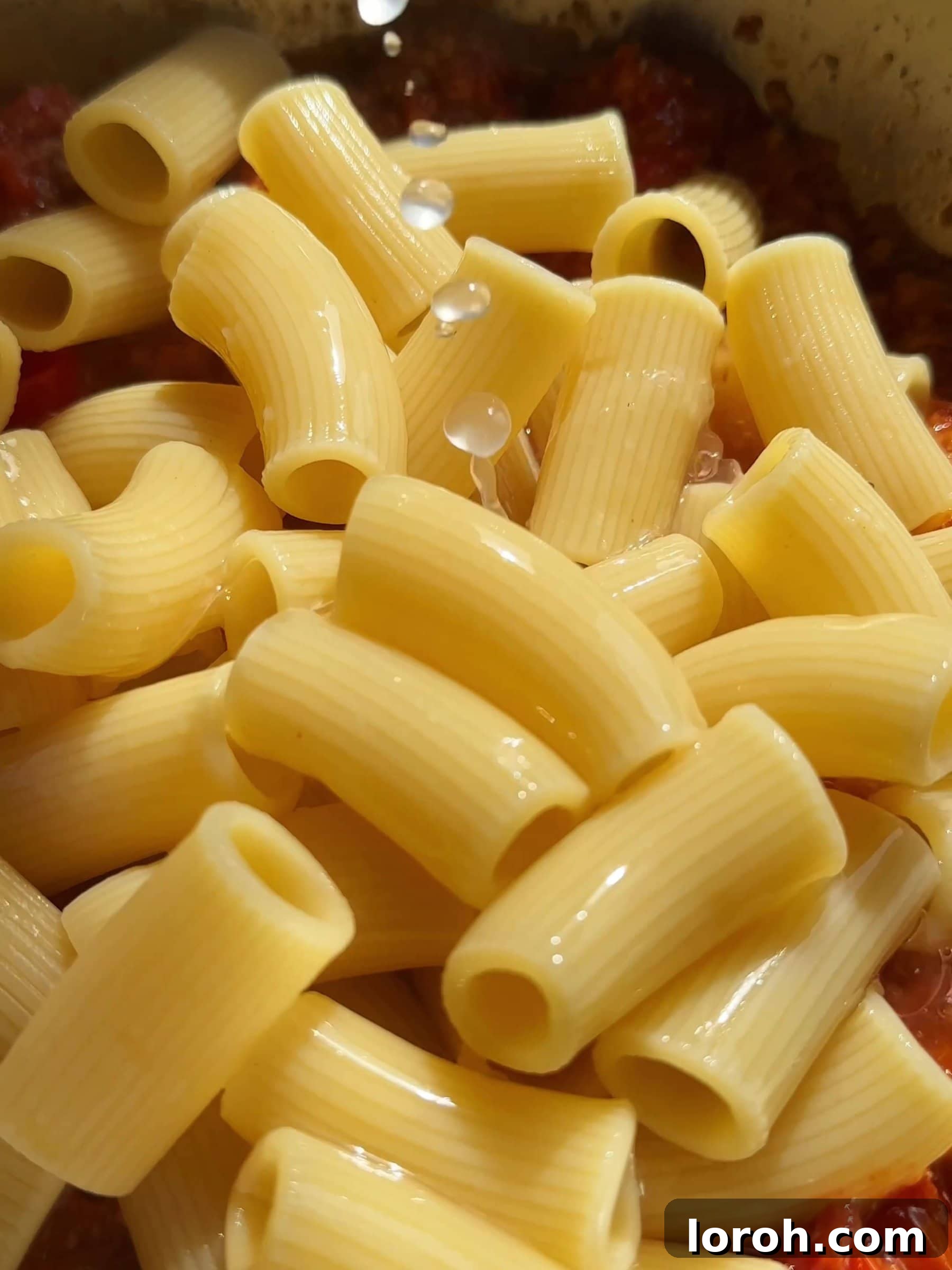 Creamy Tuna Pasta with Sweet and Spicy Tomatoes 8 Adding cooked pasta to the tuna and tomato sauce mixture.