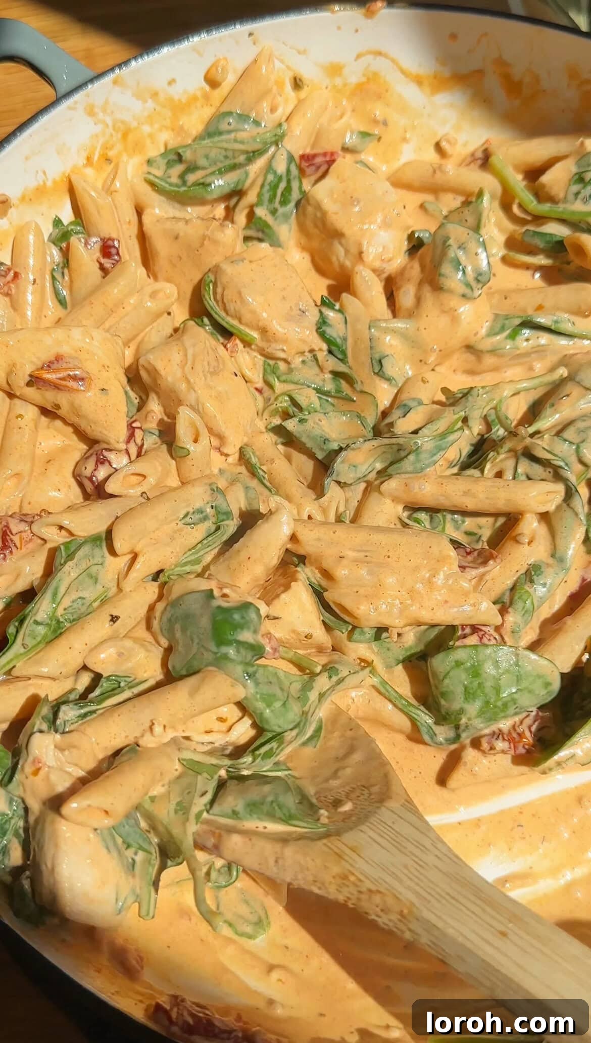 Heavenly Tuscan Chicken Pasta 8 A large pan filled with Marry Me Pasta, featuring the creamy sauce, chicken, sun-dried tomatoes, and wilted spinach, ready to be served.