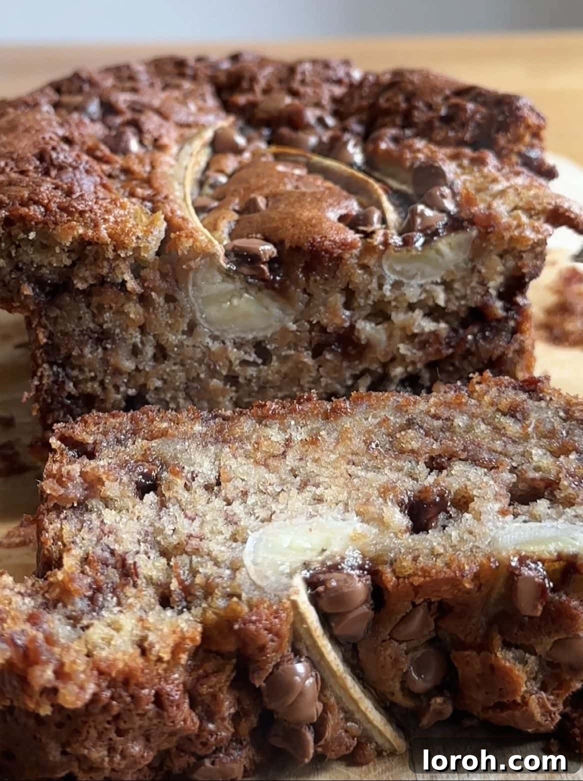 Close-up slices of moist chocolate chip banana bread, showing rich brown color, tender crumb, and generous melted chocolate chunks.