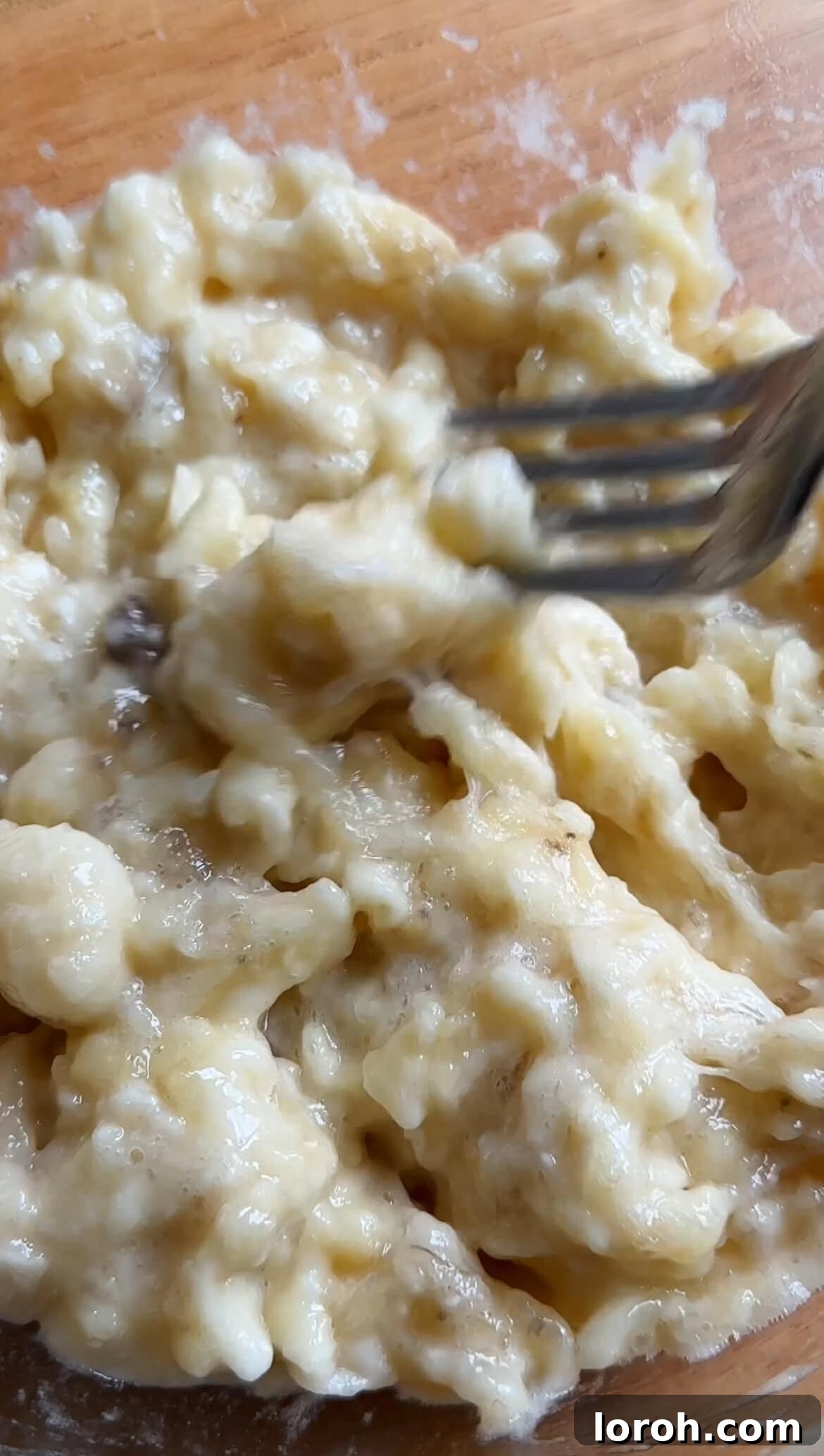 Mashing very ripe bananas into a bowl before adding to the batter.