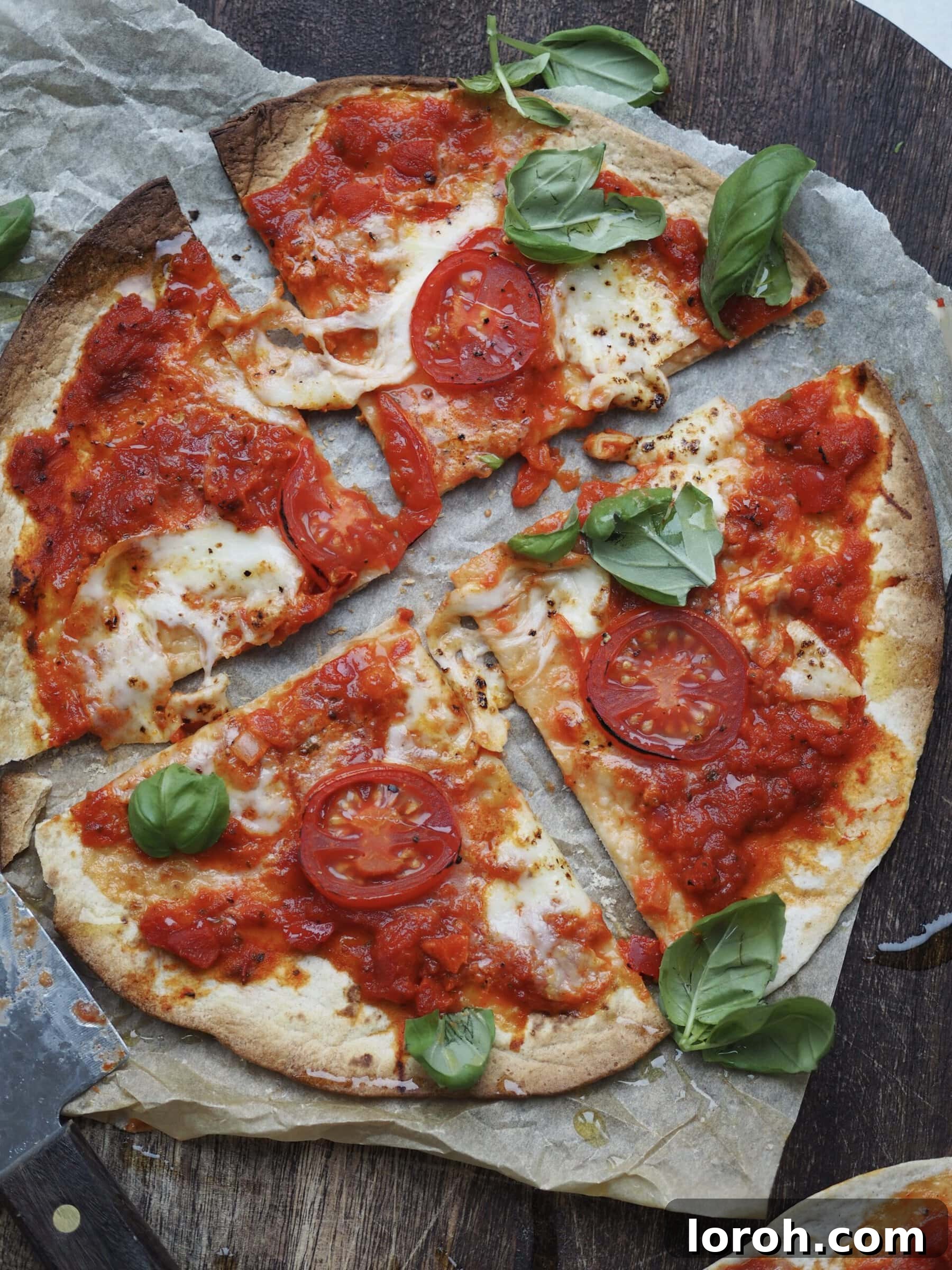 Margherita Flatbread Pizza 2 Delicious Flatbread Margherita Pizza, freshly baked and sliced into four, served on a rustic wooden board.
