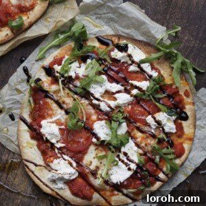 A beautifully cooked Flatbread Pizza Margherita, garnished with fresh basil, ready for serving.