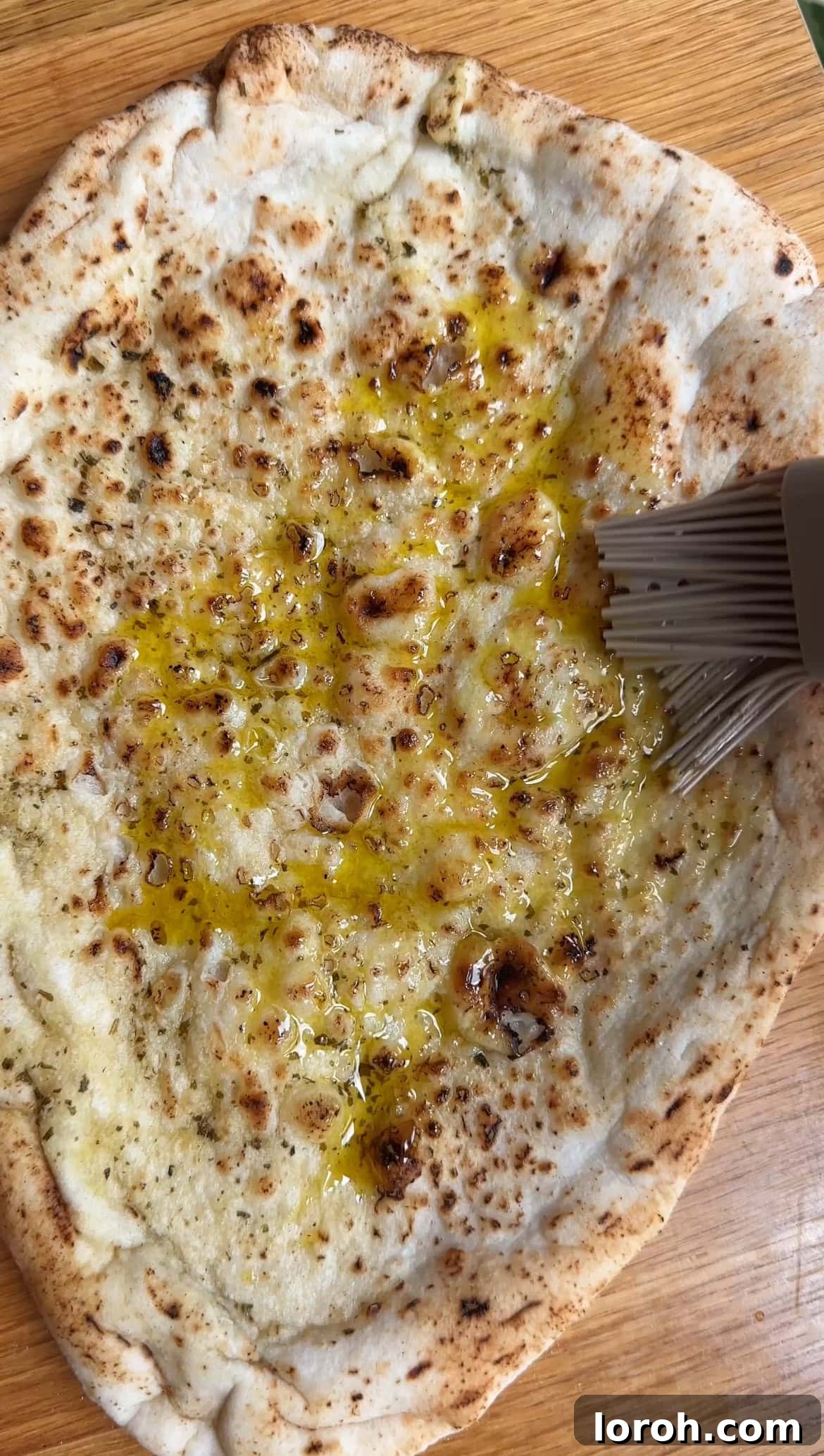 Margherita Flatbread Pizza 5 Brushing the flatbread with olive oil and seasoning it with salt, pepper, and dried herbs.