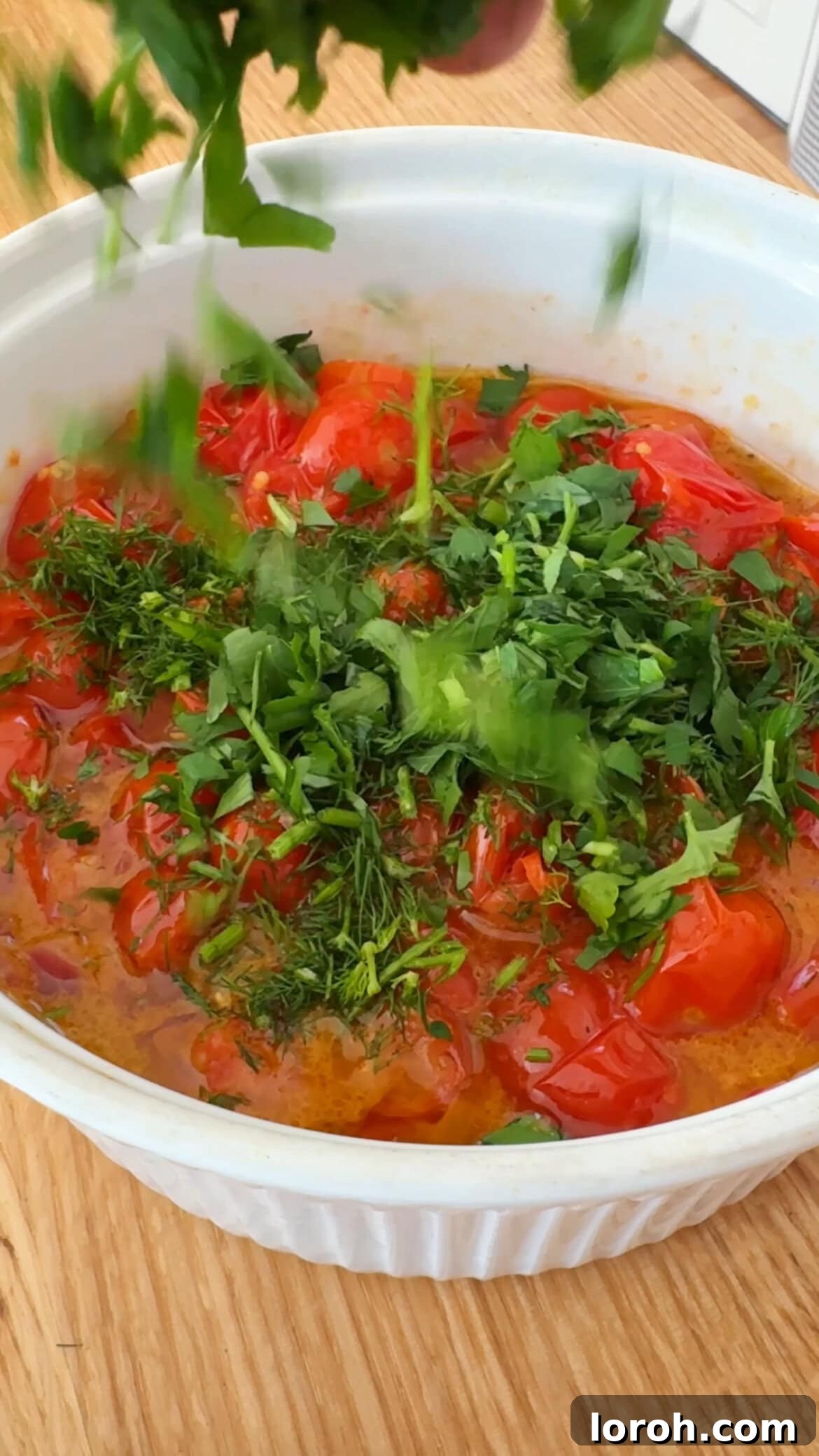Vibrant Greek Orzo Salad 6 Lots of fresh, chopped herbs being stirred into the roasted tomato and onion mixture to create the flavorful dressing.