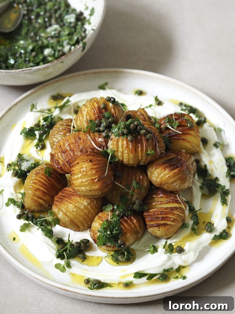 Golden Hasselback with Vibrant Salsa Verde & Tangy Labneh 2 Crispy Hasselback potatoes with fresh salsa verde served on a bed of creamy labneh.