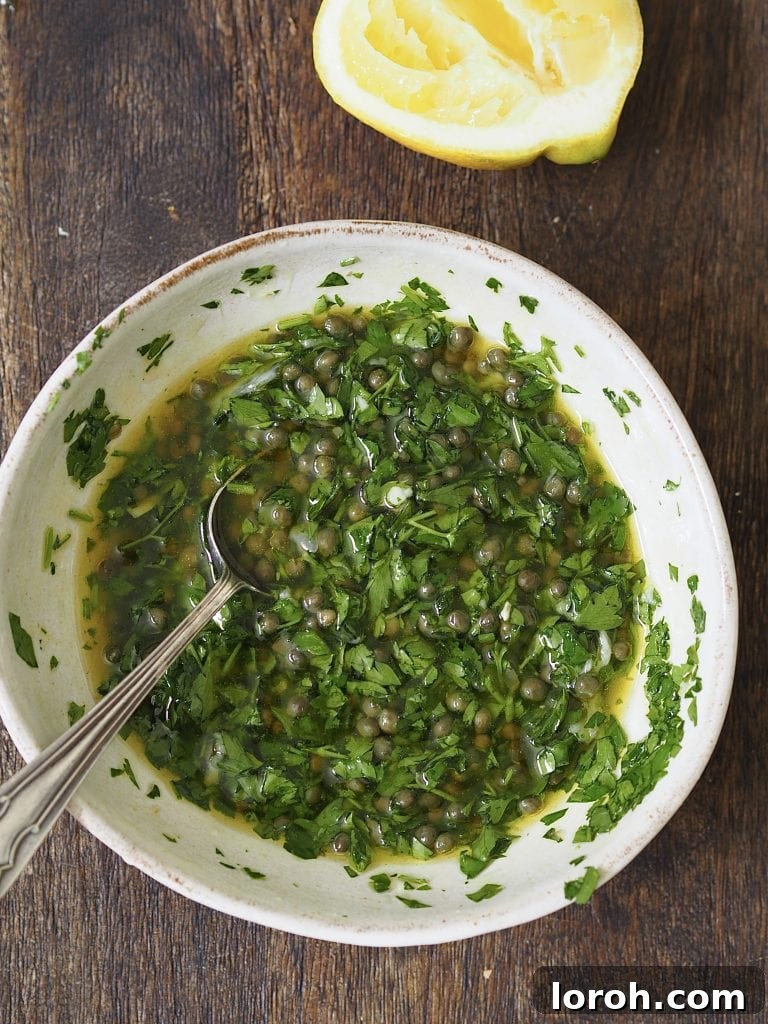 Golden Hasselback with Vibrant Salsa Verde & Tangy Labneh 9 Vibrant green salsa verde in a white bowl, perfectly mixed.