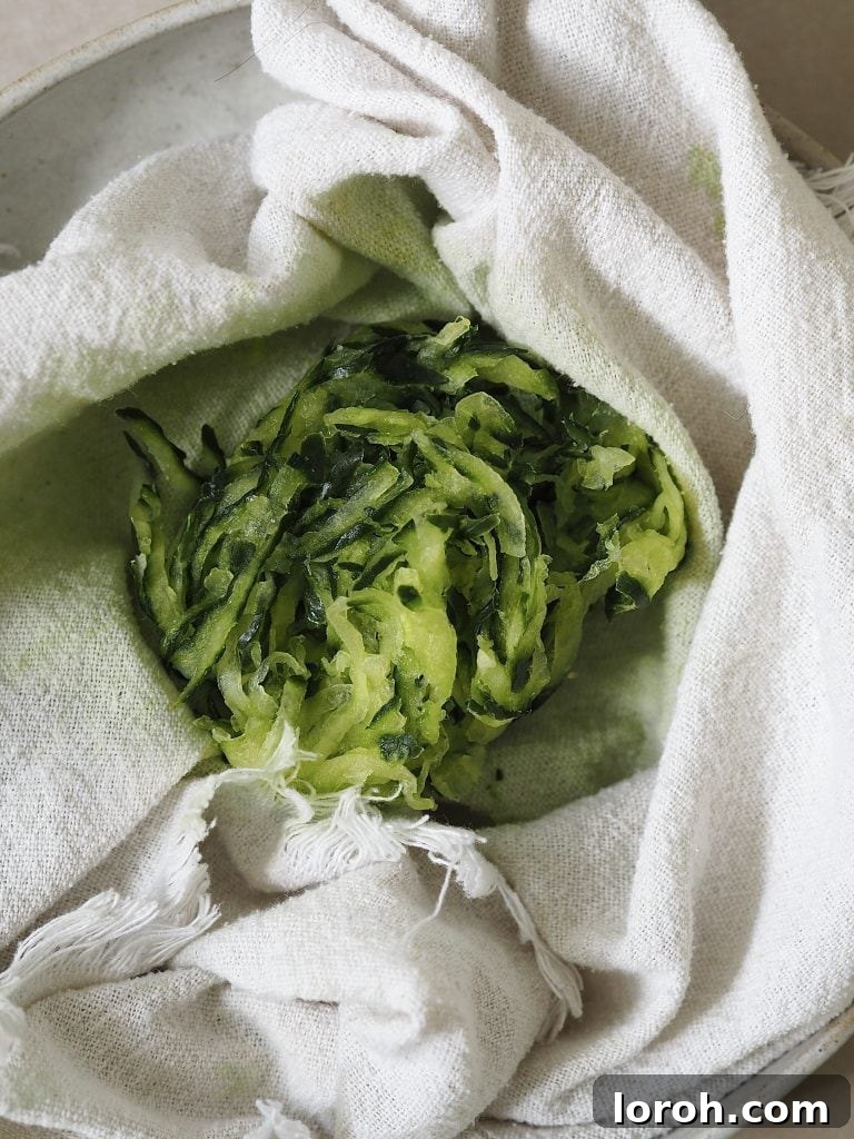 Lamb Burgers: A Fresh Mediterranean-Italian Blend 6 Grated cucumber being strained in a kitchen towel.