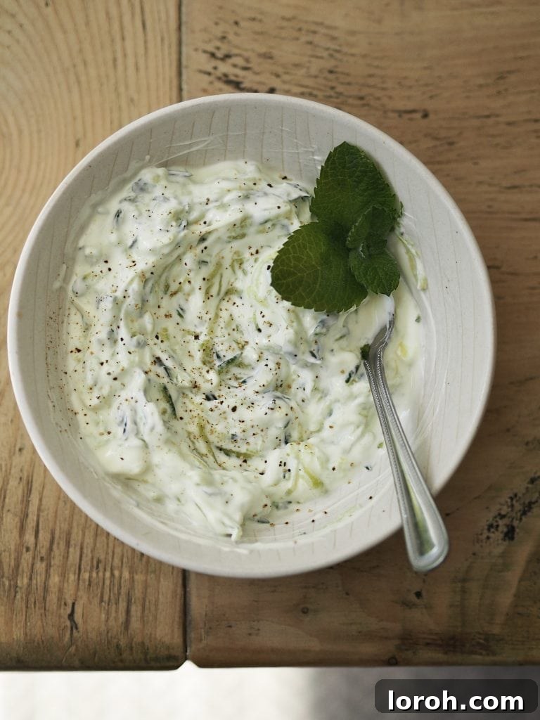 Lamb Burgers: A Fresh Mediterranean-Italian Blend 7 White bowl of tzatziki garnished with fresh mint.