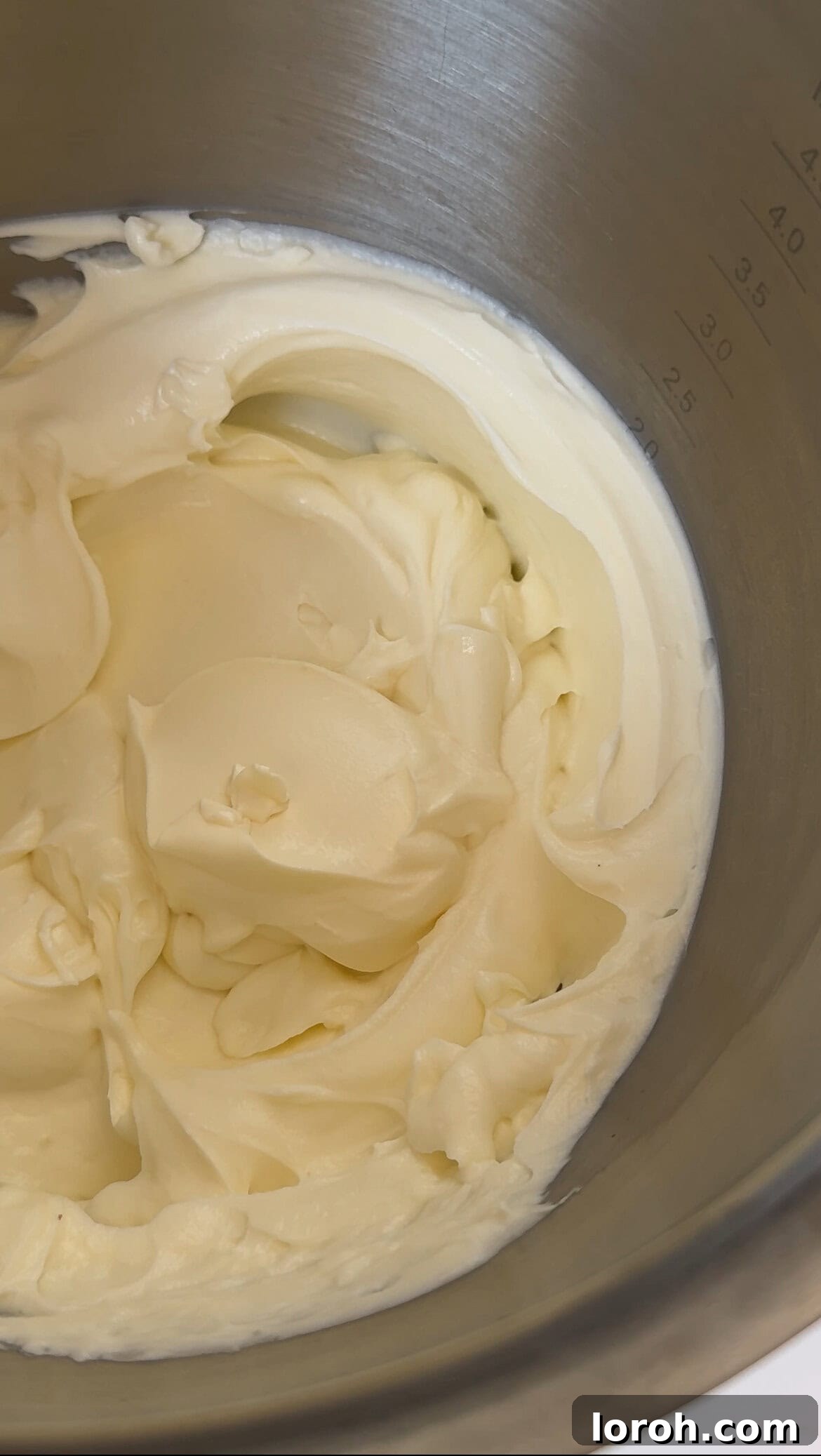Golden Torched Cheesecake 7 Cream cheese being lightly whisked in a stand mixer until smooth.