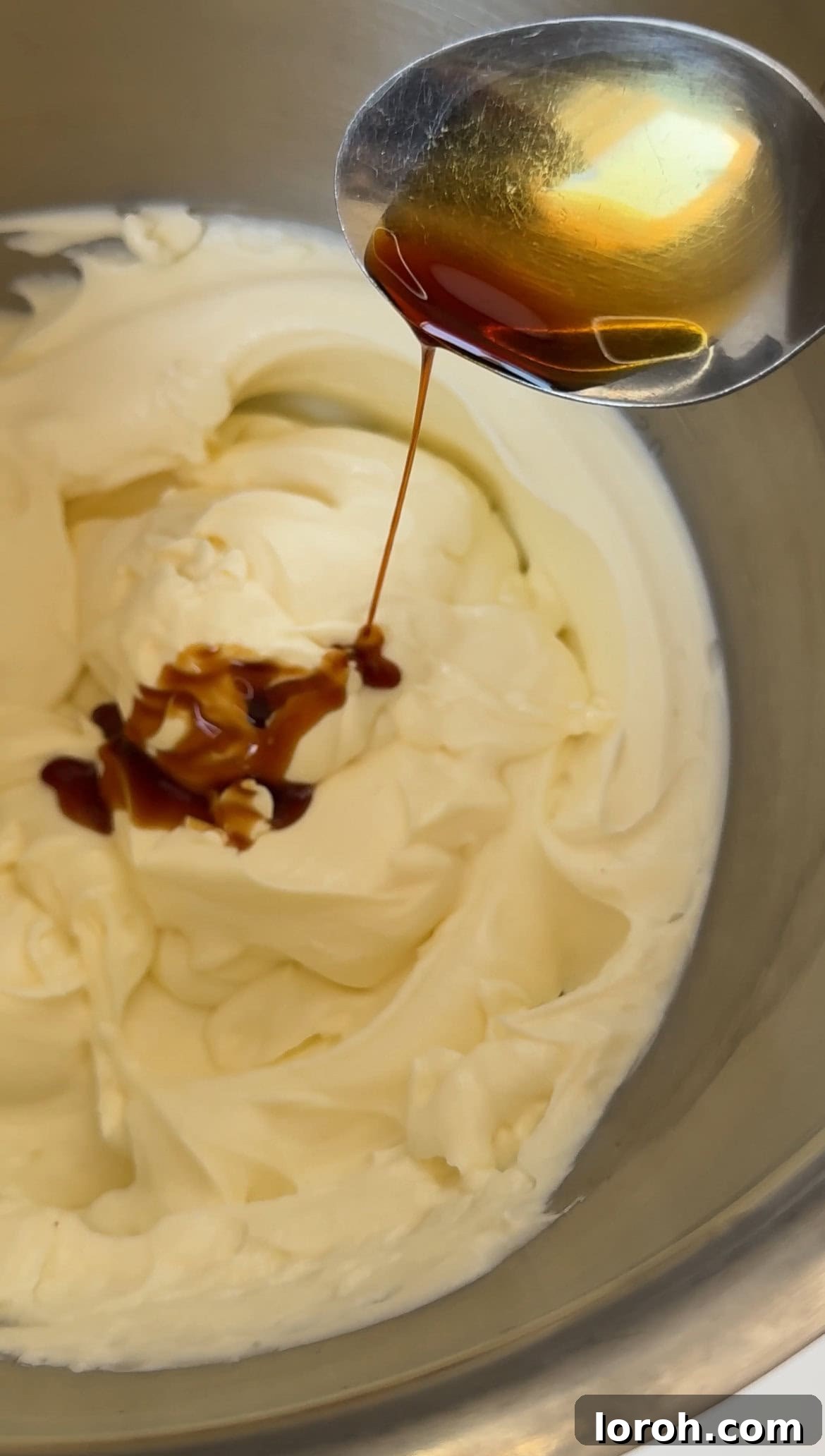 Golden Torched Cheesecake 8 Sour cream, vanilla extract, and salt being added to the cream cheese mixture.