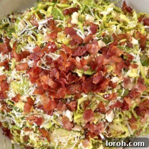 Delicious dressed sprouts with crispy bacon, almonds, and cheese
