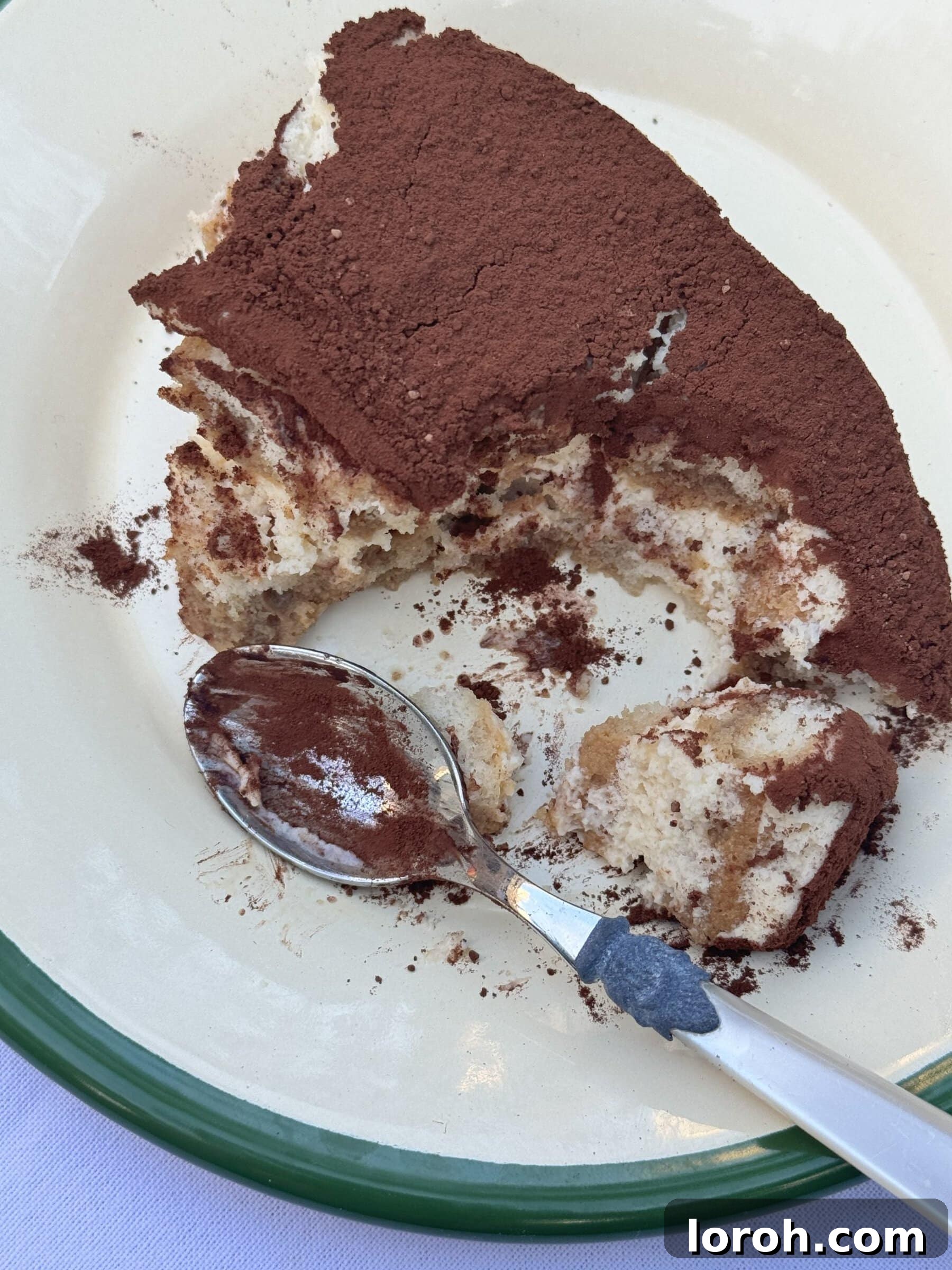 A generous scoop of rich Baileys Tiramisu, highlighting its creamy texture, defined layers, and a delicate dusting of cocoa.