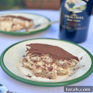 A perfectly prepared Baileys Tiramisu, ready to be served, topped with a dusting of cocoa.