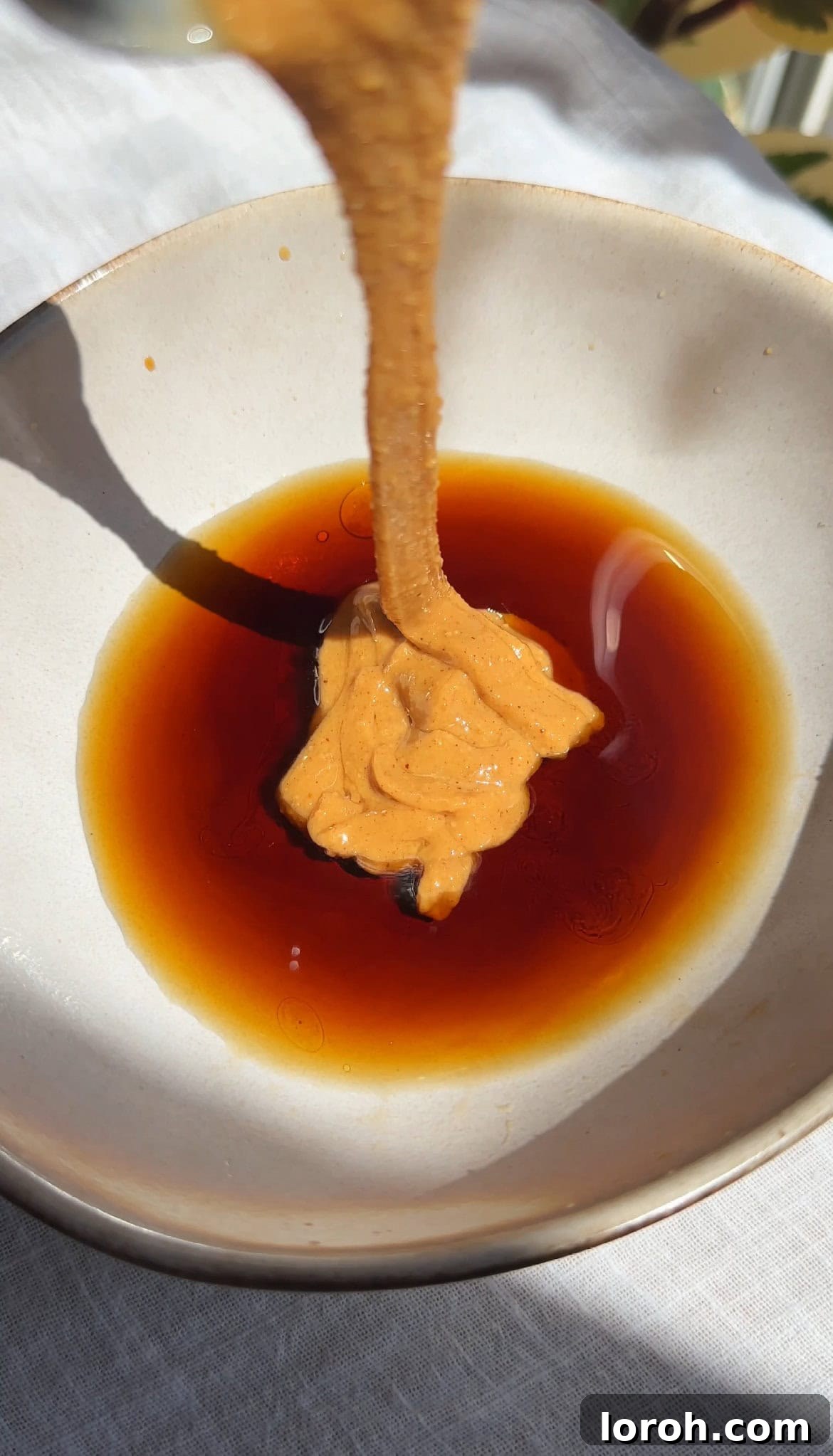 Preparing the Pad Thai sauce in a bowl, showing various ingredients being combined.