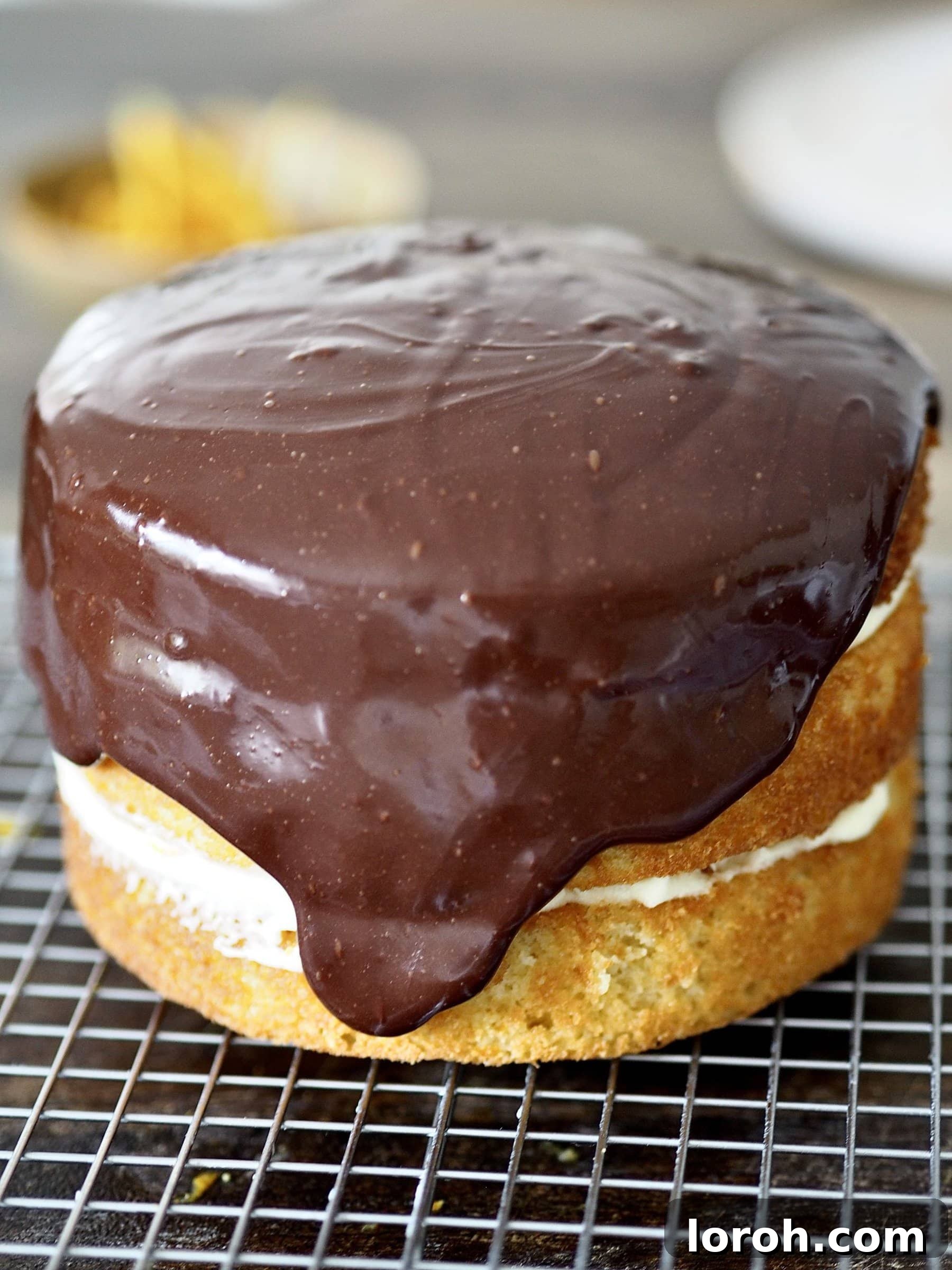 The assembled Jaffa Cake Cake covered with smooth dark chocolate ganache, ready for decoration.