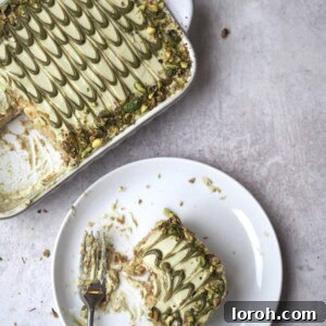 Pistachio Tiramisu in a white dish with slice on a plate.