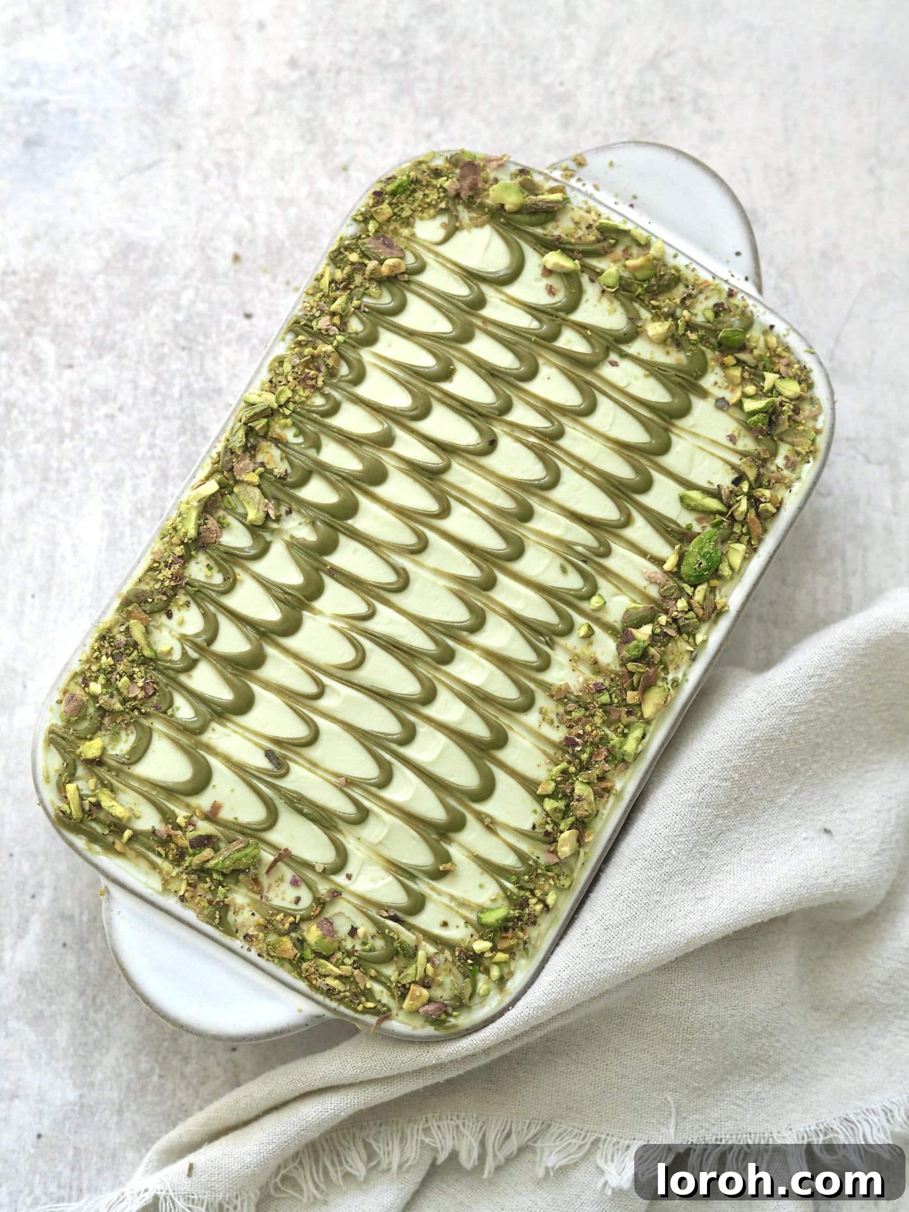 Finished Pistachio Tiramisu with decorative lines of pistachio cream.