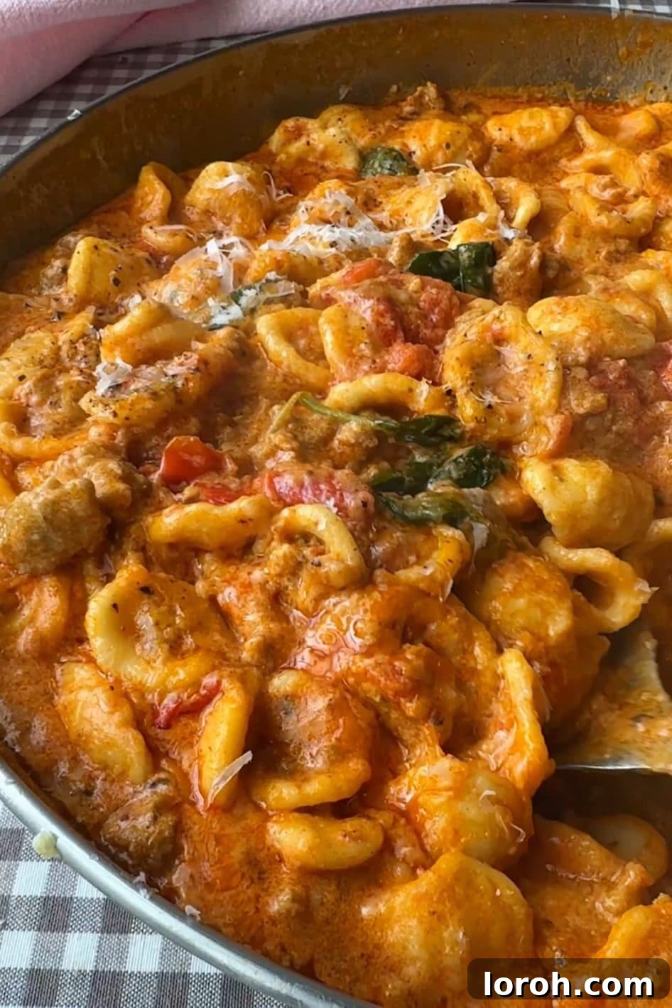 A chef stirring the finished Pasta con Nduja in a pan, ready to be served.