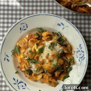 A delicious Nduja and Sausage Pasta Bake in a bowl, ready to be enjoyed.
