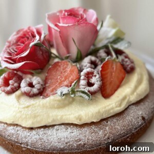 A Gâteau au Yaourt elegantly presented on a white cake stand, inviting to be sliced and enjoyed.